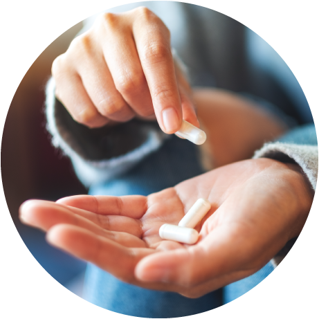 person dropping pill capsules into hand
